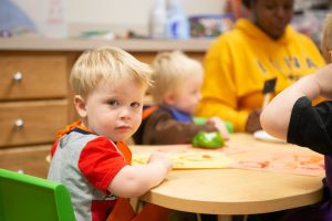 Toddler in daycare at table